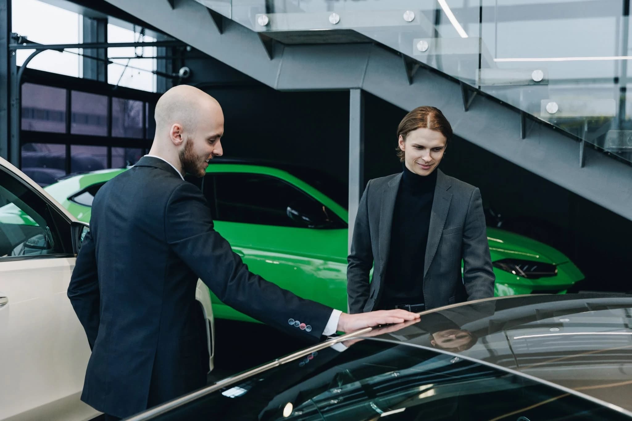 A Ferati sales consultant showing a client a car in the showroom