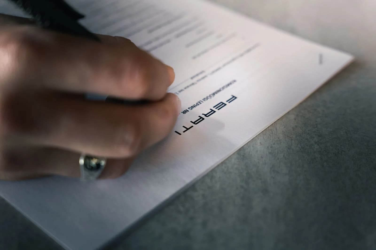 A client signing Ferati's commission sale agreement